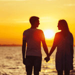 couple holding hands while walking on a beach during sunset for post called 5 ways self-care can improve intimacy in your marriage