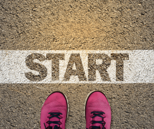 Motivation - Pink tennis shoes at starting line