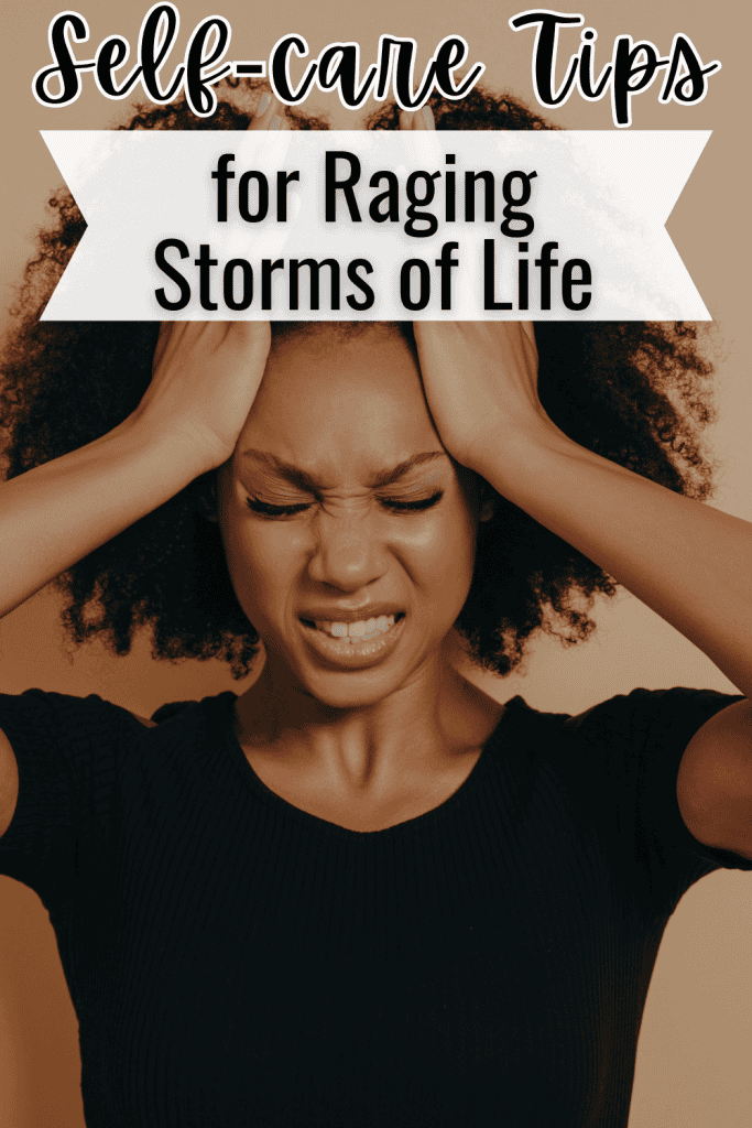 stressed woman holding her temples and grimacing.