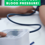 a healthcare worker helping a woman take her blood pressure.