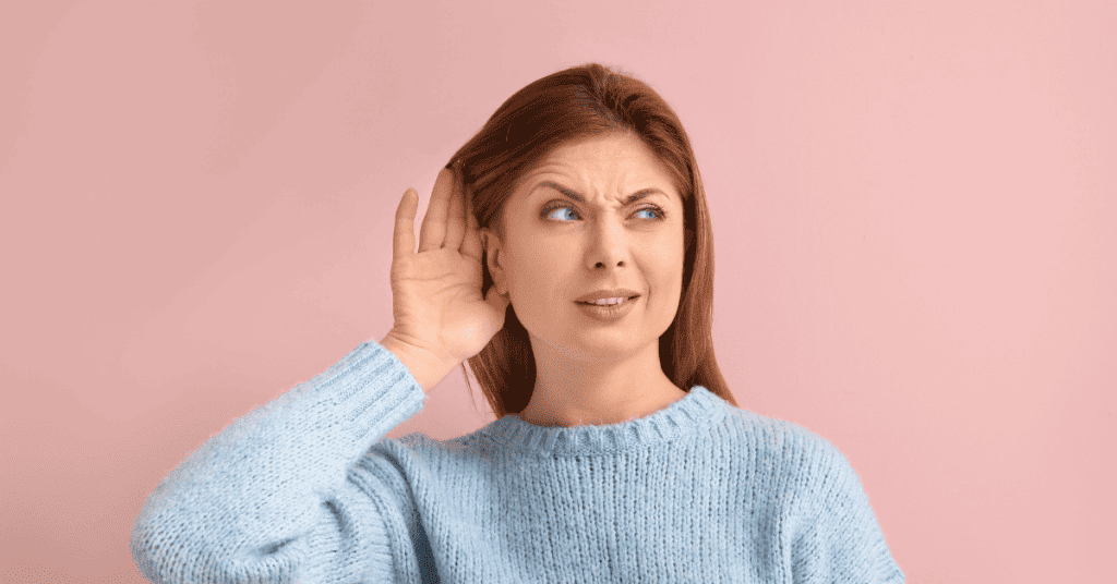 Woman with hand by ear having difficulty hearing - 3 Simple Ways How to Treat Hearing Loss Due to Allergies