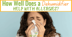 young light-skinned woman with long curly brown hair blowing her nose
