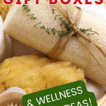 brown basket containing self-care items: candles, loofah, brush, bath salts, sponge, washcloth for post called best self-care gift boxes and wellness basket ideas